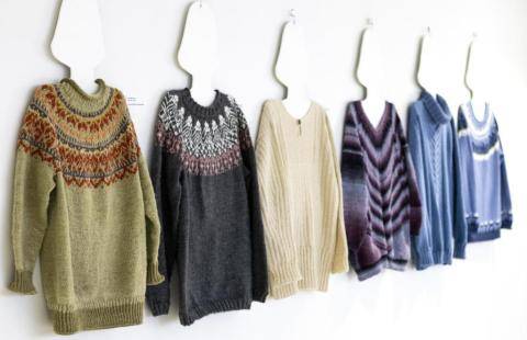 A row of knitted sweaters made by Raahe-opisto students