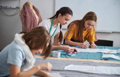 Children planning a sewing project.